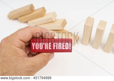 Business And Finance Concept. In The Foreground, A Hand With A Red Wooden Block And The Inscription 