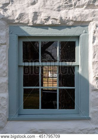 Gorgeous Golden Hour Landscape Viewed Through Two Windows In A Colonial Whitewashed Stone Cottage Wi