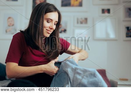 Woman Cutting Her Jeans For Summer Making Short Pants