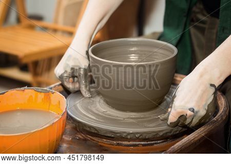 Potters Hands Cutting Pot With Cut-off Wires Close Up. Woman Works In Pottery Workshop. Clay Bowl Sp