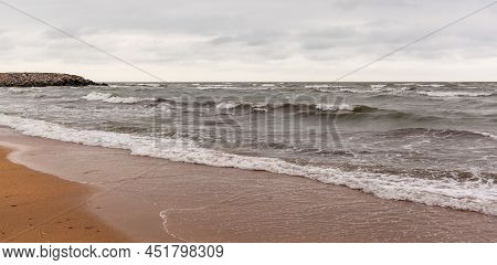 Huge Waves Raging In The Sea And Seagulls In The Spray Of Waves. Storm At Sea. Birds Fly Over The Wa