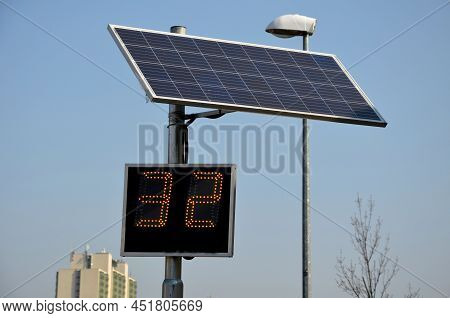 Radar To Measure The Speed Of Vehicles In The City. A Reflective Green Sign On A Pole With Led Light
