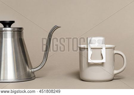 Drip Coffee Bag With Ground Coffee In Big Cup, Hot Water Is Poured Into Paper Filter Drip Coffee For