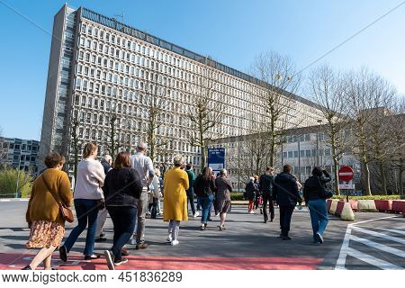 Schaerbeek, Brussels Capital Region, Belgium - 03 26 2022 - Visitors Walking Towards The Headquarter