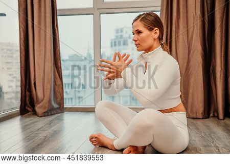 Athletic Slim Caucasian Woman Doing Thigh Self-massage With A Massage Ball Indoors. Self-isolating M