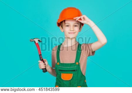 Child Dressed As A Workman Builder. Little Boy Wearing Helmet. Portrait Little Builder In Hardhats H