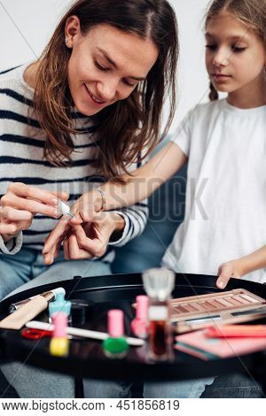 Mother And Daughter Doing Manicure At Home, Painting Nails With Nail Polish