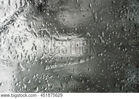 Close The Misted Glass With Water Drops Flowing Down. Dripping Condensation, Drops Of Water. Backgro