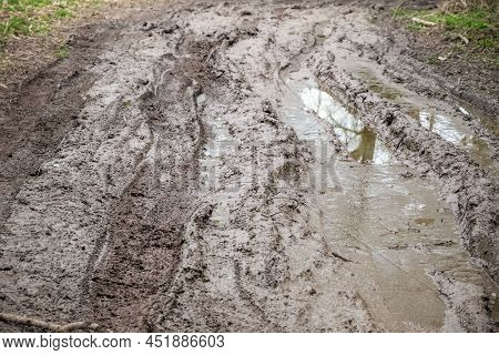 Extremely Muddy Trail With Messy Tire Tracks Next To River Cole In Whelford, England