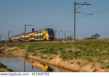 Amsterdam, Netherlands, March 2022. Dutch Train In The Landscape And In The Central Station