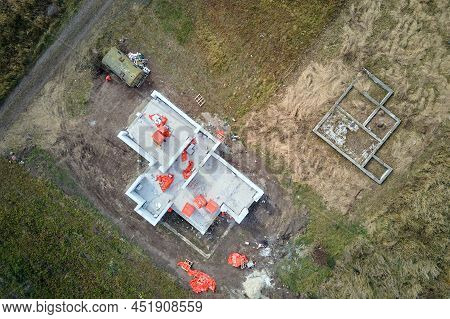 Aerial View Of Unfinished Frame Of Private House Foundation Under Construction.
