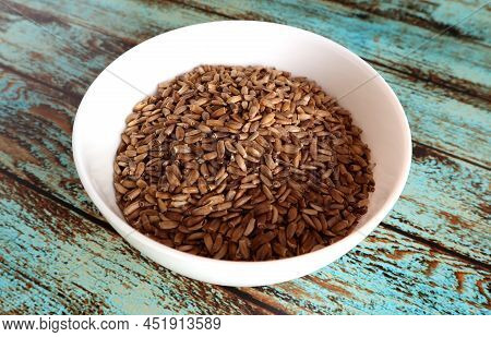 Whole Unpeeled Milk Thistle Seeds In A White Bowl On An Old Shabby Wooden Background. Hepatoprotecto