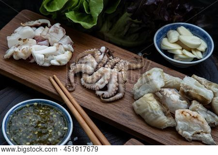 Fresh Grilled Squid, Octopus Tentacles And Squids Eggs On Wooden Tray Served With Fresh Vegetables, 