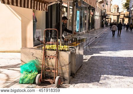 Athens, Greece, Murch 2022 - . A Street Vendor Of Freshly Baked Corn Is Waiting For Buyers To Arrive