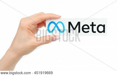 Kiev, Ukraine - January 20, 2022: Hand Holds Meta Logo, Printed On Paper. Social Media Giant Faceboo