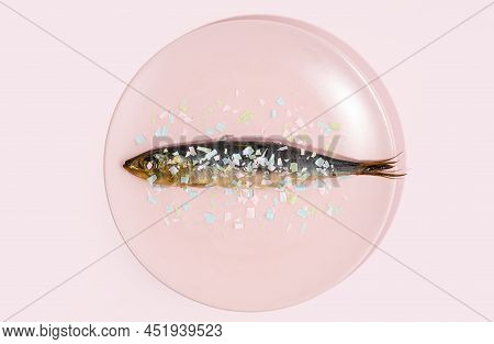 Fish Covered Microplastic On A Pink Plate. Impact Of Micro Plastic On The Food Chain. The Idea Of Mi