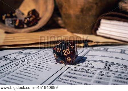 Close-up Image Of A 20-sided Gaming Dice On A Character Sheet