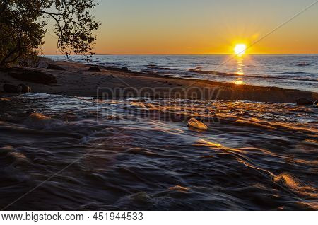 The Sun Sets Over The Hurricane River Just As It Flows Into Lake Superior, Pictured Rocks National L