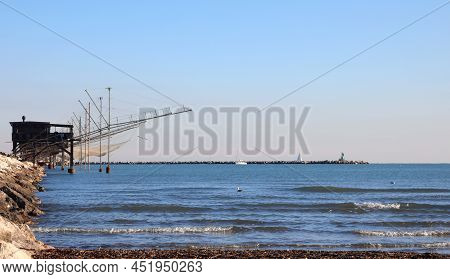 Fishing Huts On The Long Dam And Large Nets For Catching Fish And The Blue Sea