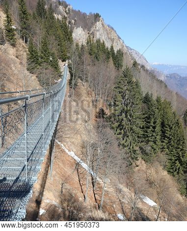 Long Tibetan Bridge Connecting The Mountain Ridges In Winter Without People
