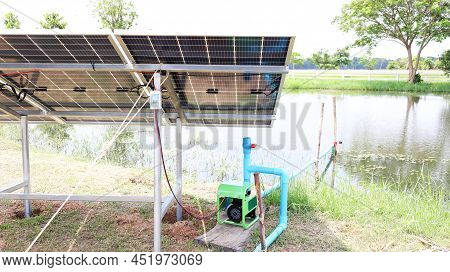 Solar Panels And Water Pump. Photovoltaic Panel For Outdoor Pumps To Supply Water To Agricultural Pl
