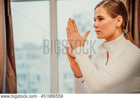 Athletic Slim Caucasian Woman Doing Thigh Self-massage With A Massage Ball Indoors. Self-isolating M