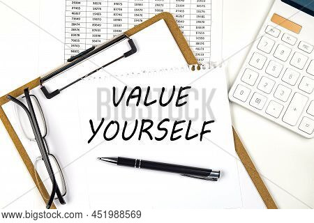 Text Value Yourself On White Paper On Clipboard With Chart And Calculator