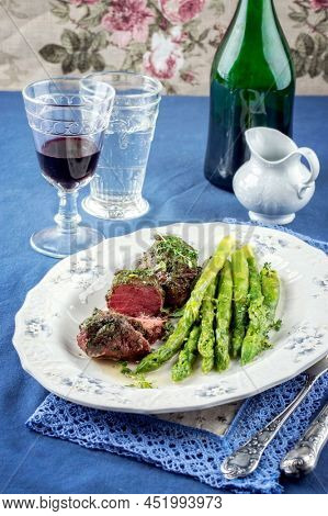 Medaillons with Green Asparagus on Plate