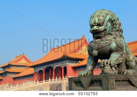 Lion statue and historical architecture in Forbidden City in Beijing, China.