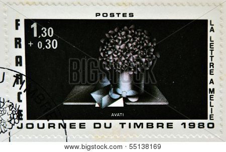 A stamp printed in France shows etching the black way the letter melie Avati