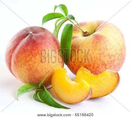 Ripe peach fruit with leaves and slises on white background.