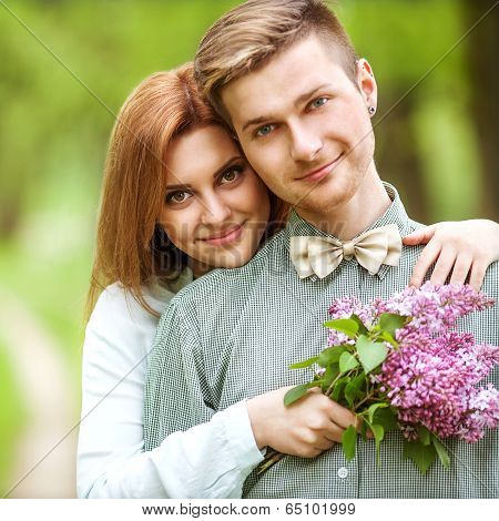 Couple In Love In Blooming Apple Trees Garden, Smiling . Valentine's Day