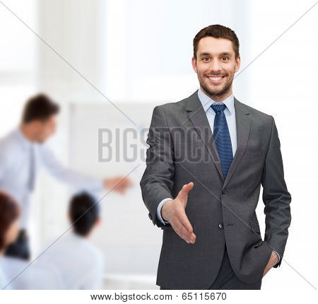 business and office concept - handsome businessman with open hand ready for handshake