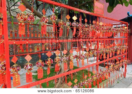 MACAU - APRIL 14 : Red Prayer Papers and Remembrances with Bells at A-Ma Temple on April 14, 2013 in Macau. The temple was built in 1488 and It is one of the oldest Taoist temples in Macau.