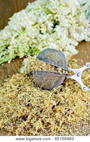 Herbal Tea From Dry Meadowsweet In Strainer On Board