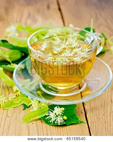 Herbal Tea From Linden Flowers In Glass Cup On Board