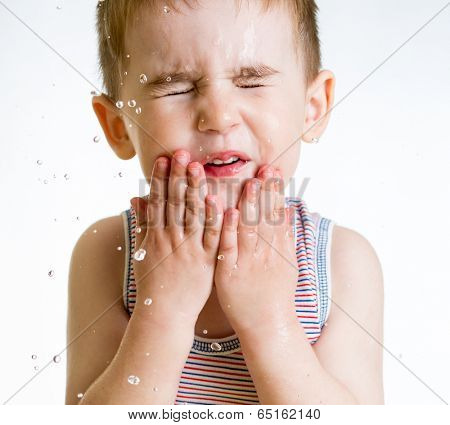squint little child washing face