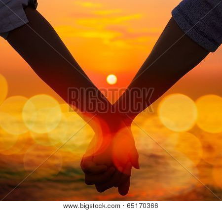 Couple Holding Hands at Sea Sunset