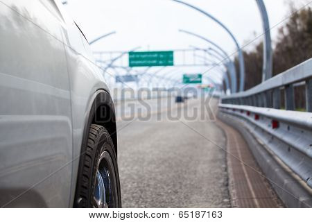 Car Standing On Wayside With Side Road View