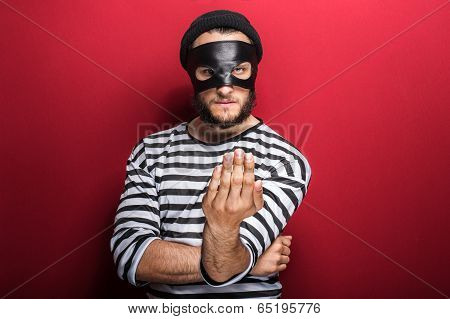 Angry criminal inviting with hand