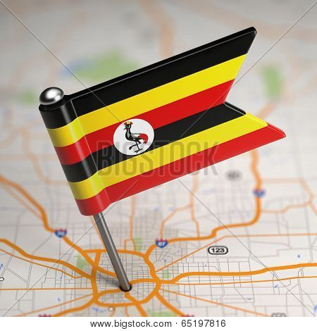 Uganda Small Flag on a Map Background.