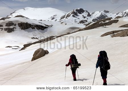 Two Hikers On Snowy Plateau