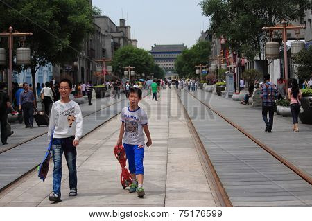 people are walking on Qianmen pedestrian street in Beijing
