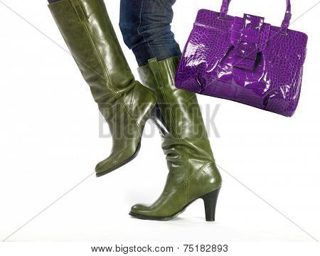woman in fashion boots and trendy bag steps