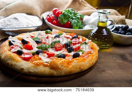 delicoius fresh pizza with tomatoes, olives and basil