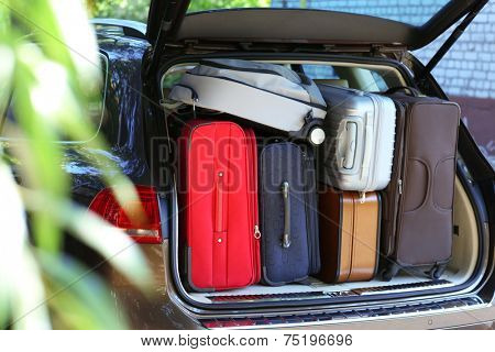 Suitcases and bags in trunk of car ready to depart for holidays