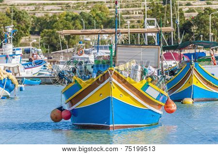 Traditional Luzzu Boat At Marsaxlokk Harbor In Malta.