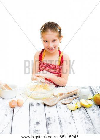 cutre little girl making dough on the kitchen