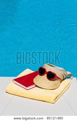 utensils for a nice relaxing vacation day lying next to a swimming pool. relaxation on vacation.