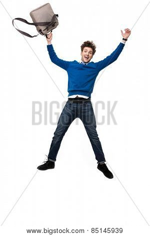 Laughing business man jumping with bag over white background